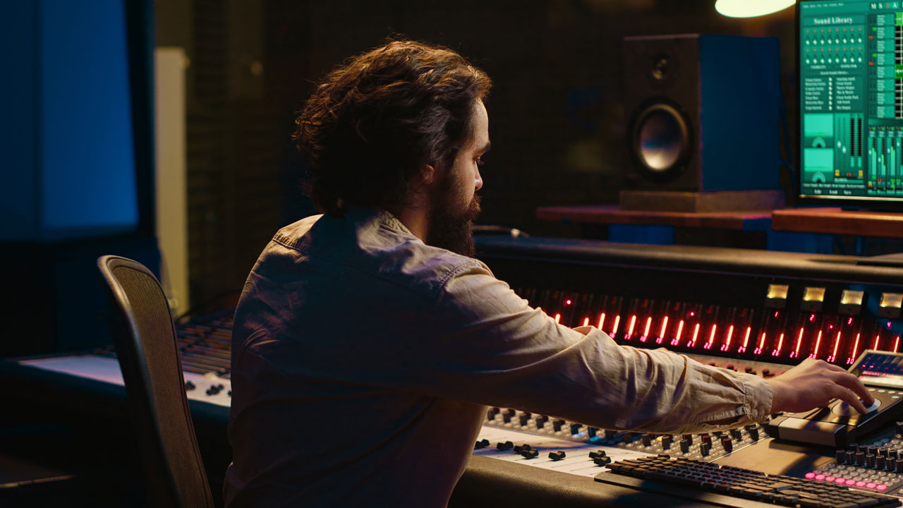portrait-music-producer-working-control-room-professional-studio