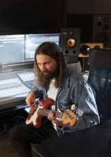 medium-shot-man-playing-guitar-studio